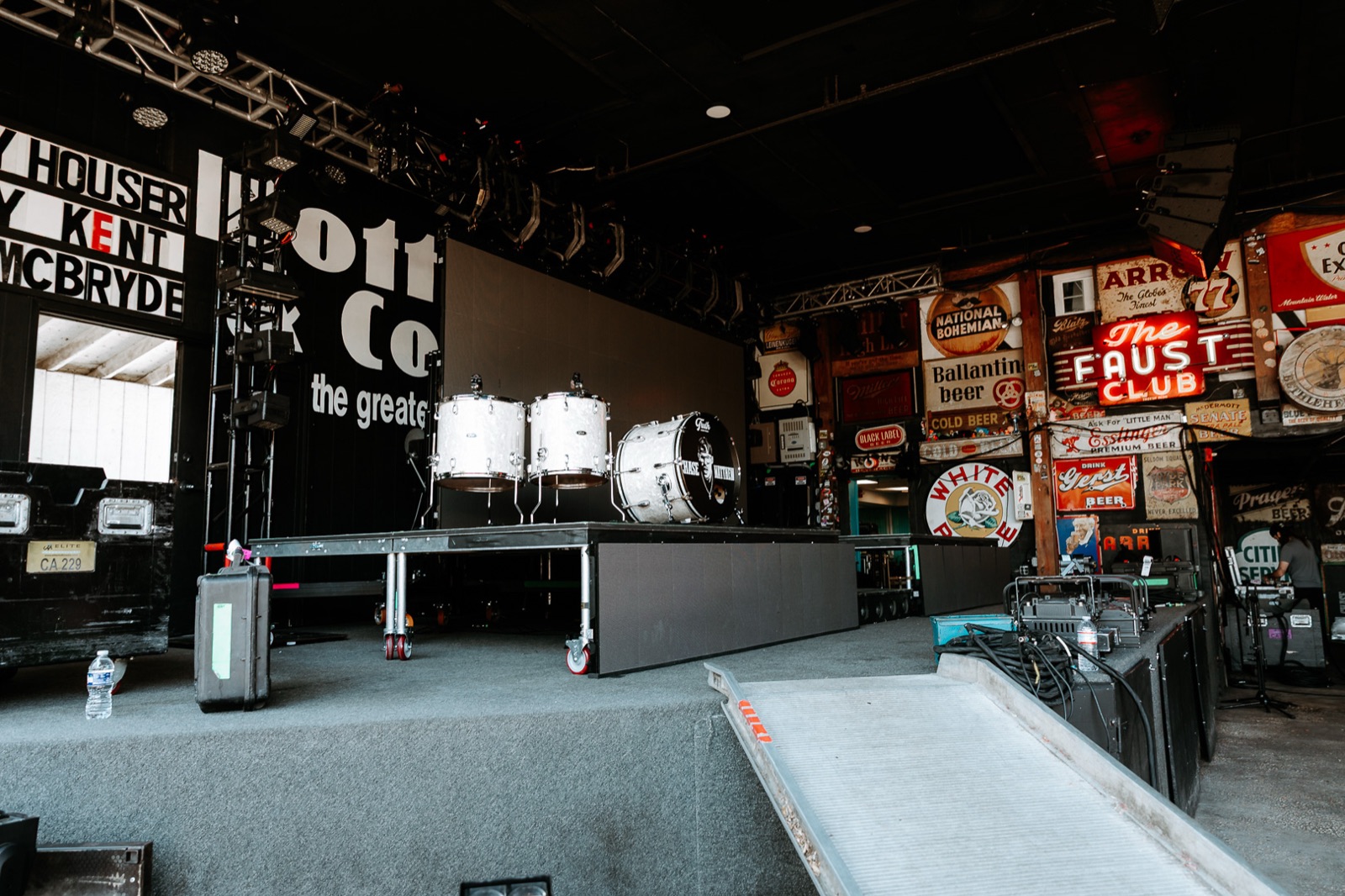Empty venue stage in daylight before the gear arrives