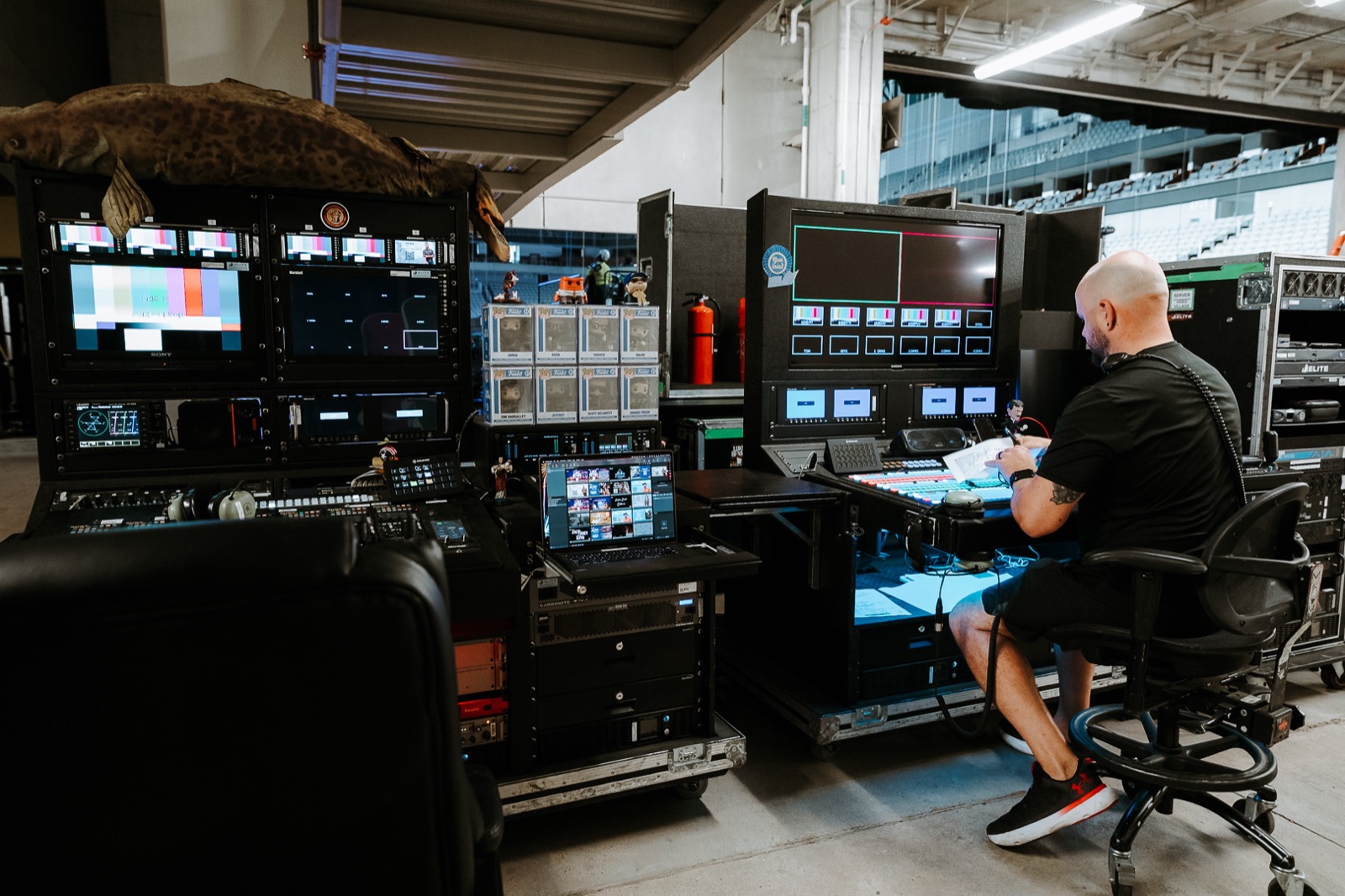 Engineer working at the front-of-house desk, monitors lit